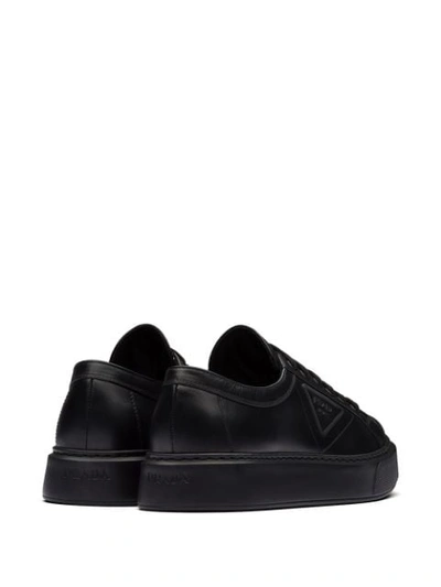 Shop Prada Logo Embossed Low-top Sneakers In Black