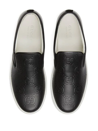 Shop Gucci Gg-embossed Slip-on Sneakers In Black