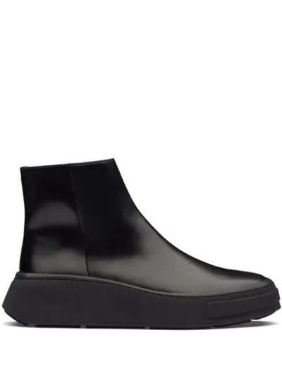 Shop Prada Zipped Wedge Sole Boots In Black