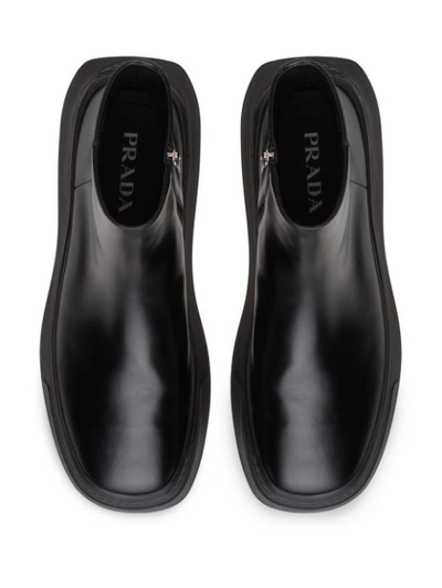 Shop Prada Zipped Wedge Sole Boots In Black