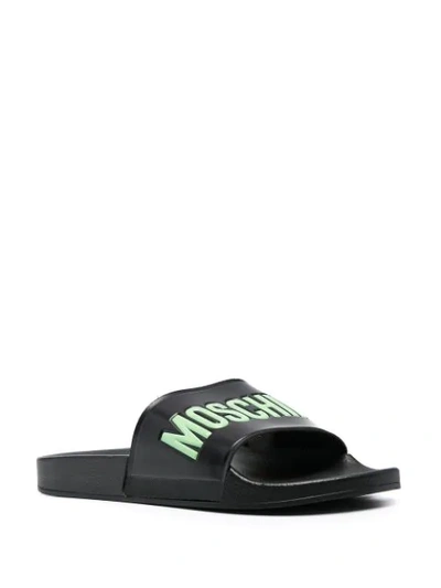 Shop Moschino Logo Embossed Slides In Black