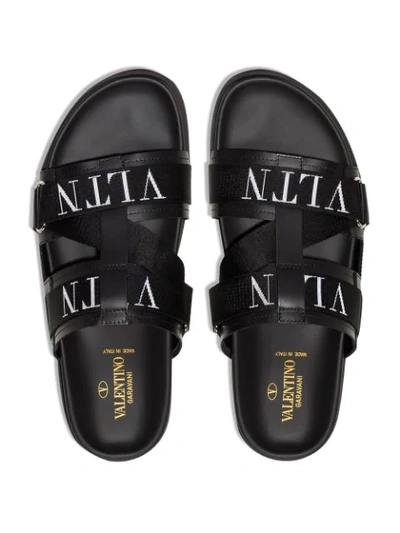 Shop Valentino Vltn Leather Slides In Black