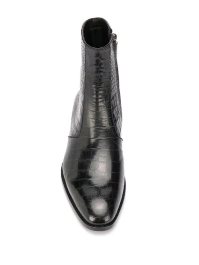 Shop Saint Laurent Wyatt Crocodile-embossed Boots In Black