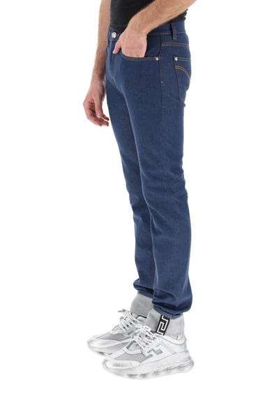 Shop Versace Taylor Fit Jeans With Greca In Blu Indigo