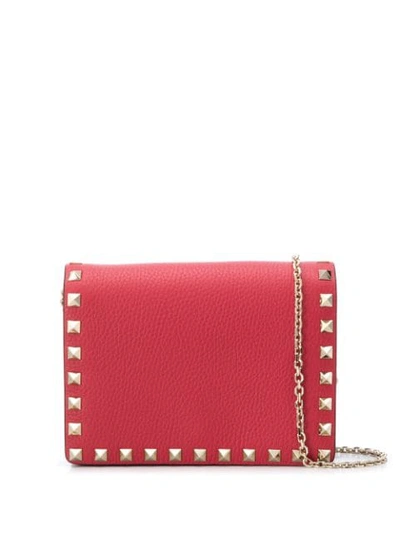 Shop Valentino Small Rockstud Crossbody Bag In Pink