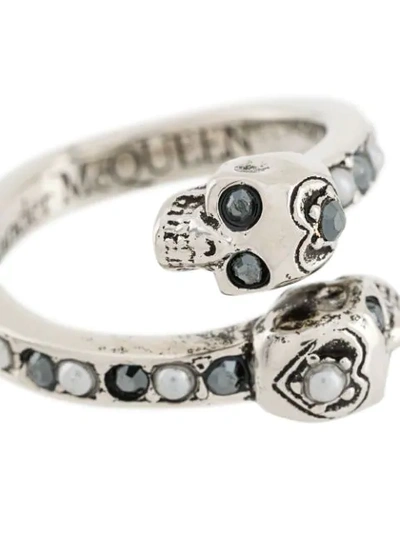 Shop Alexander Mcqueen Twin Skull Embellished Ring In Metallic
