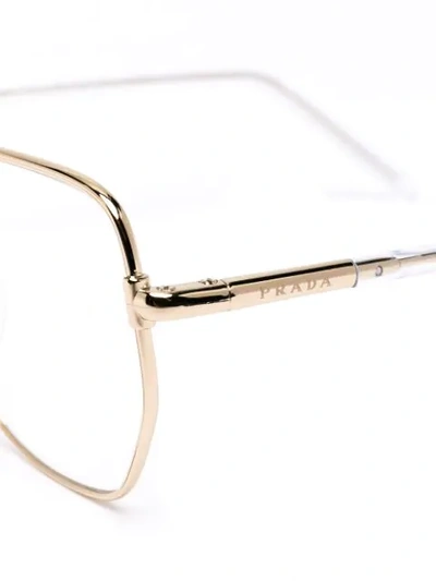 Shop Prada Oval Wire-frame Optical Glasses In Gold