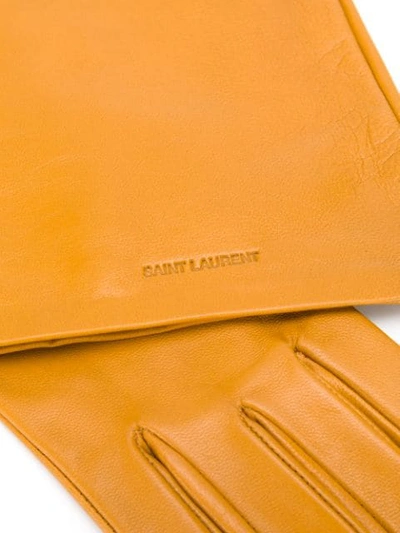 Shop Saint Laurent Logo-embossed Long Gloves In Yellow