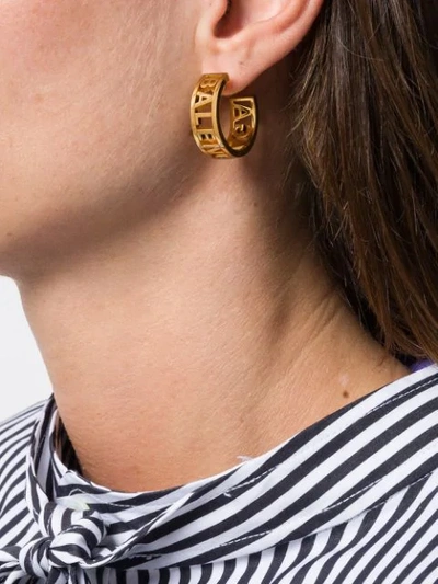 Shop Balenciaga Logo Earrings In Gold