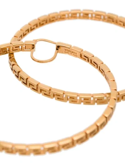 Shop Versace Greca-pattern Hoop Earrings In Gold