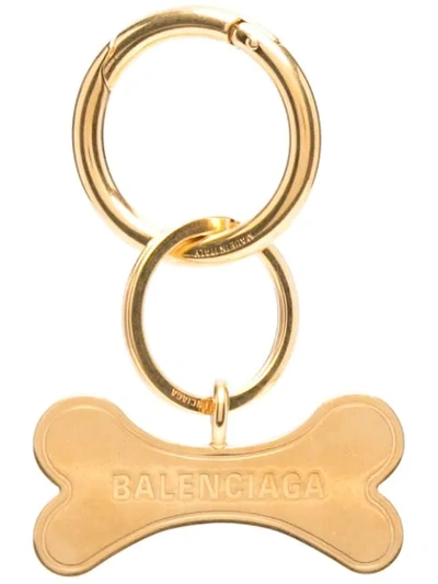 Shop Balenciaga Pet Bone Keyring In Gold