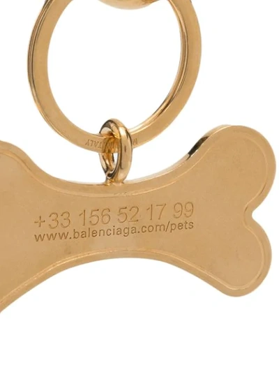 Shop Balenciaga Pet Bone Keyring In Gold