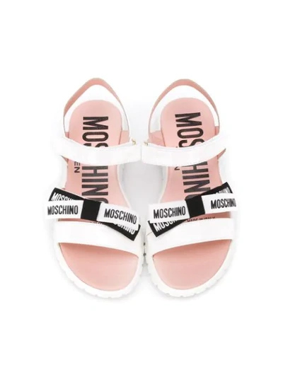 Shop Moschino Logo Bow Sandals In White