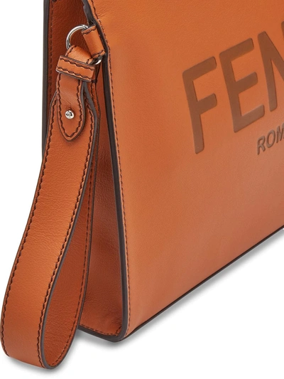 Shop Fendi Debossed-logo Wrist Strap Pouch In Brown