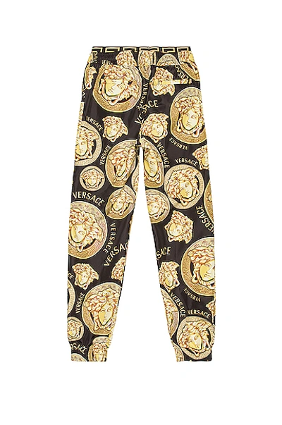 Shop Versace Allover Print Pant In Black & Gold
