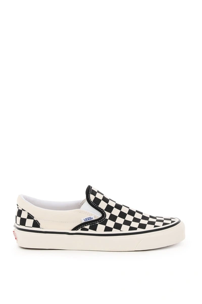 Shop Vans Classic Slip-on Checkerboard Sneakers In Black White