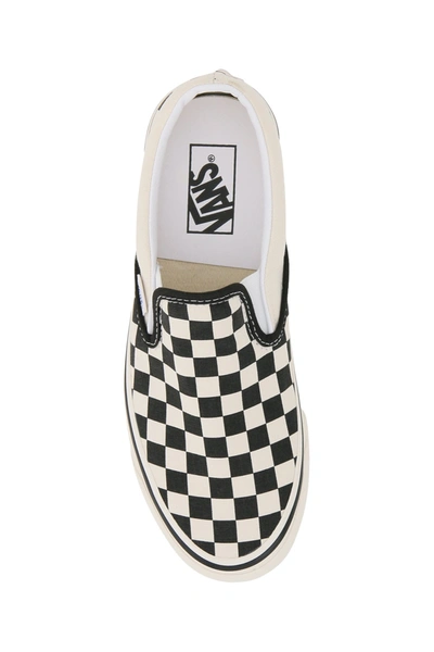Shop Vans Classic Slip-on Checkerboard Sneakers In Black White