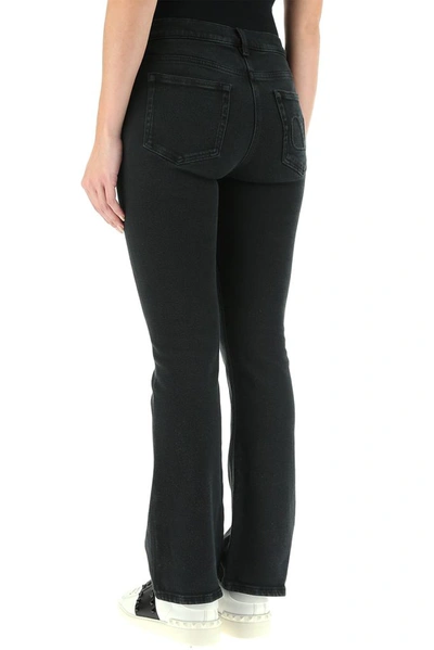 Shop Valentino Quote Embroidered Flared Jeans In Black