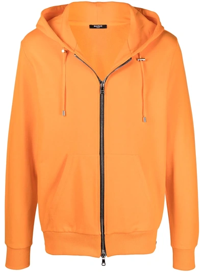 Shop Balmain Zipped Logo Embossed Hoodie In Orange