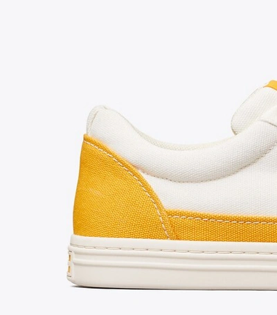 Shop Tory Burch Classic Court Sneaker In Ivory Canvas/ Curry Yellow