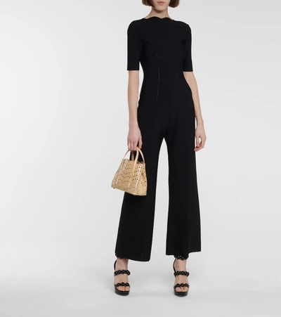 Shop Alaïa Stretch-knit Flared Jumpsuit In Black