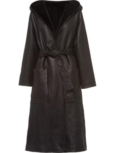 Shop Prada Reversible Hooded Shearling Coat In Black