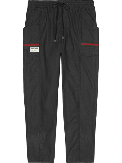 Shop Gucci Coated Cotton Trousers With  Label In Black