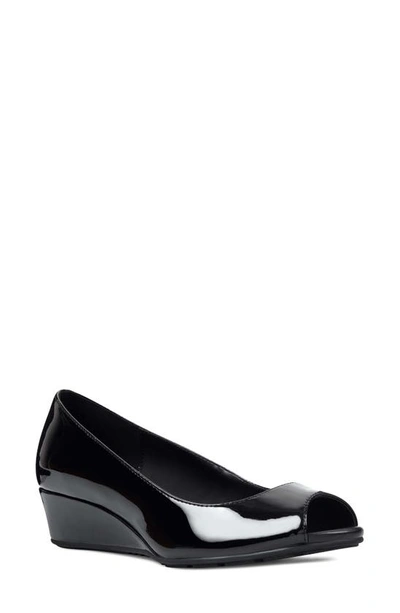 Shop Bandolino Peep Toe Wedge Pump In Black Faux Patent Leather