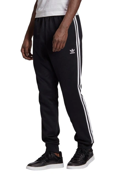 Shop Adidas Originals Adicolor Classics Primeblue Sst Track Pants In Black/ White