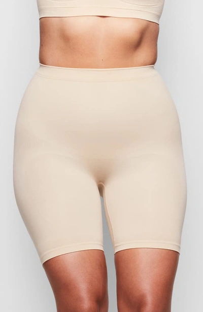 Shop Skims Sculpting Mid Thigh Shorts In Clay