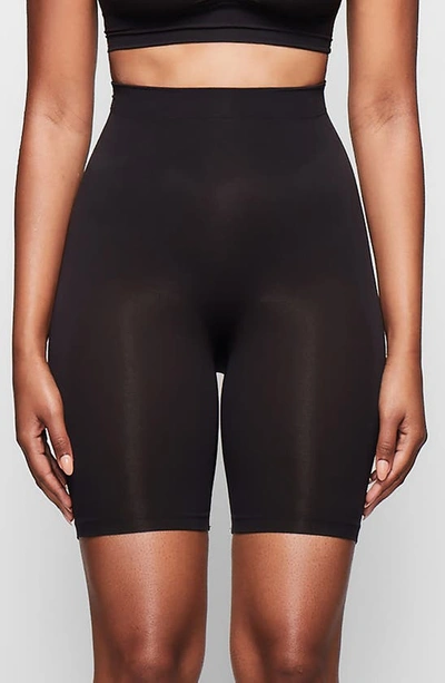 Shop Skims Sculpting Mid Thigh Shorts In Onyx