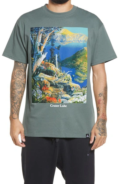 Shop Nike Acg Crater Lake Graphic Tee In Clay Green/ White