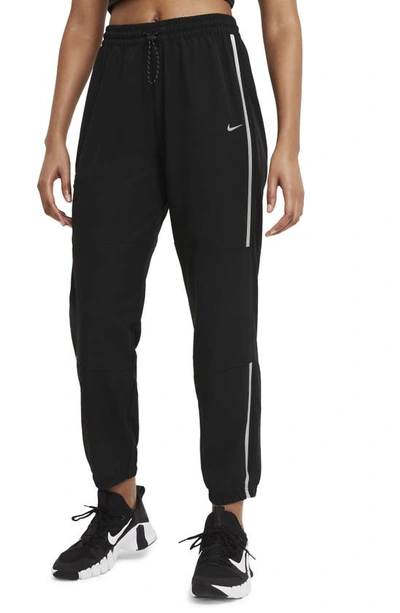 Shop Nike Pro Woven Pants In Black/ Metallic Silver