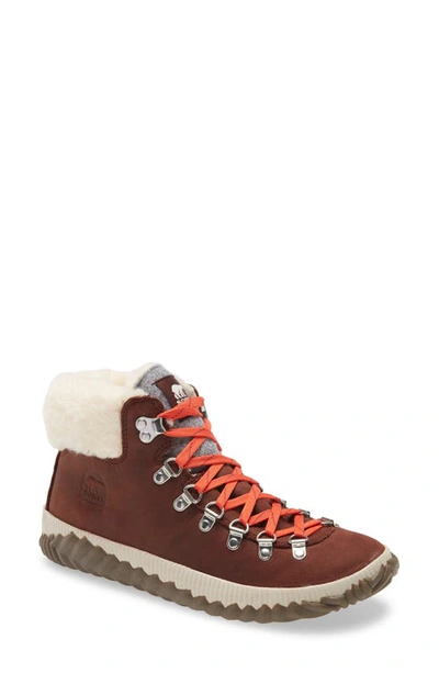 Shop Sorel Out 'n About(tm) Conquest Waterproof Bootie With Faux Fur Trim In Redwood