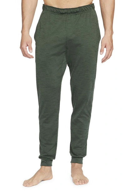 Shop Nike Pocket Yoga Pants In Galactic Jade/sequoia