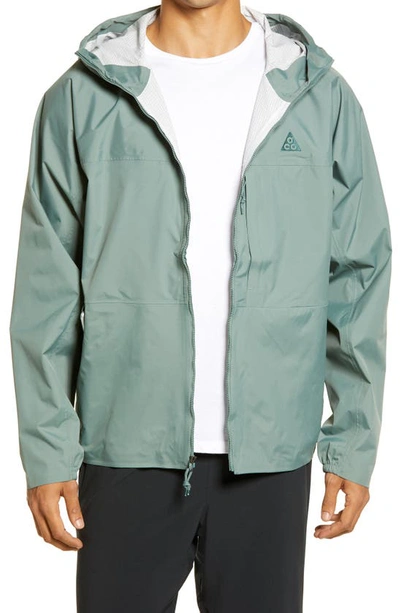 Shop Nike Acg Tuff Nuggets Packable Rain Jacket In Clay Green/ Green Stone