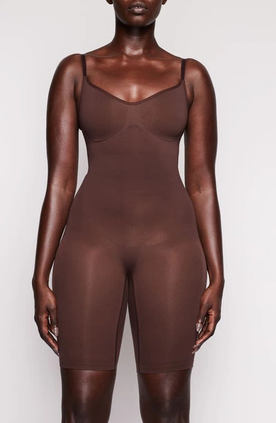 Shop Skims Sculpting Seamless Mid Thigh Bodysuit In Cocoa