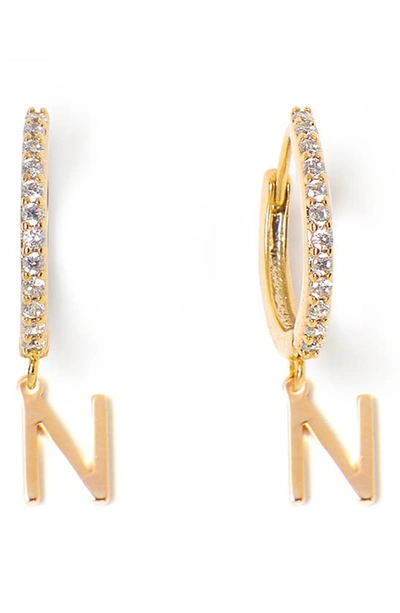 Shop Tess + Tricia Initial Huggie Hoop Earrings In Gold N