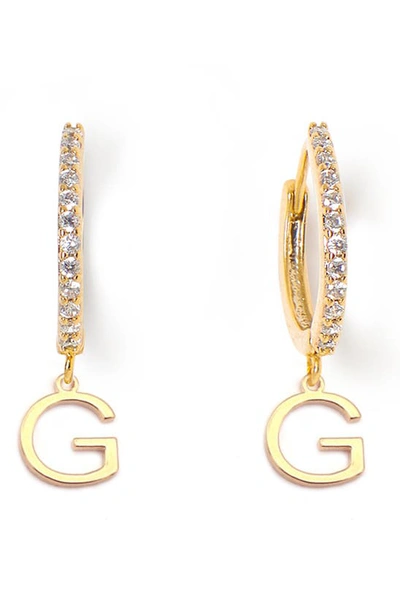 Shop Tess + Tricia Initial Huggie Hoop Earrings In Gold G