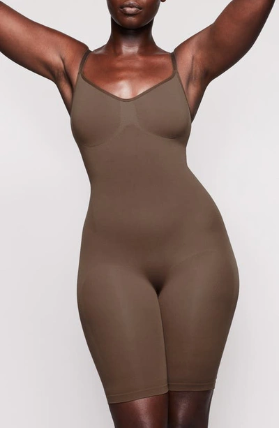 Shop Skims Sculpting Seamless Mid Thigh Bodysuit In Oxide