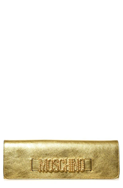 Shop Moschino Logo Metallic Leather Clutch In Gold