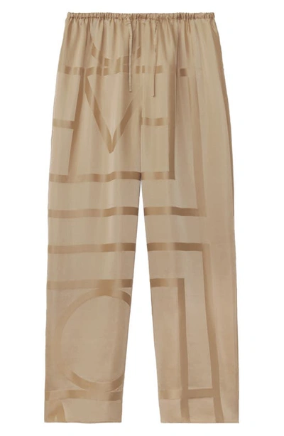 Shop Totême Monogram Silk Pajama Bottoms In Cafe Au Lait