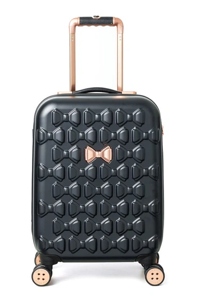 Shop Ted Baker Small Beau 22-inch Bow Embossed Four-wheel Trolley Suitcase In Black