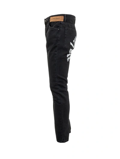 Shop Palm Angels Curved Logo Print Jeans In Black