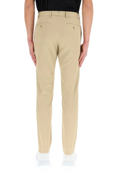 Shop Burberry Tapered Chino Trousers In Beige