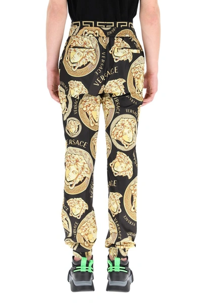 Shop Versace Graphic Print Track Pants In Multi