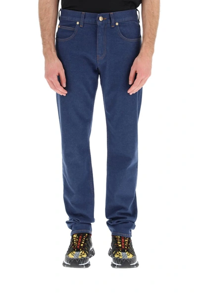 Shop Versace Logo Patch Straight Leg Jeans In Blue