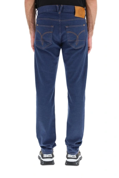 Shop Versace Logo Patch Straight Leg Jeans In Blue