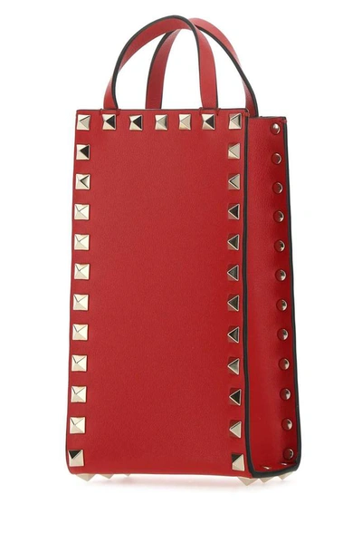 Shop Valentino Garavani Rockstud Mini Top Handle Bag In Red