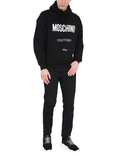 Shop Moschino Logo Print Hoodie In Black